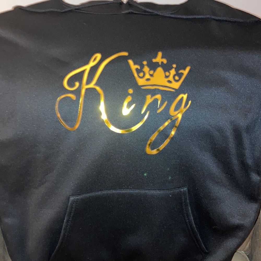 Mens hoodie says KING on the front in gold wording